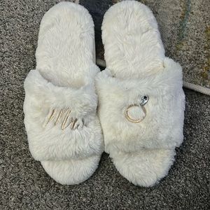 Cute fuzzy bridal slippers with a bling ring on the left slipper.